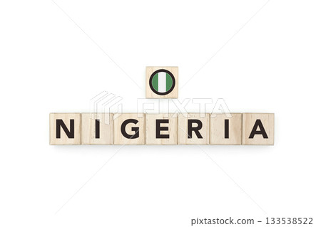 Wooden blocks bearing the name and flag of Nigeria. Nigerian and African Culture, national identity, travel, and geography in a copy space design. 133538522