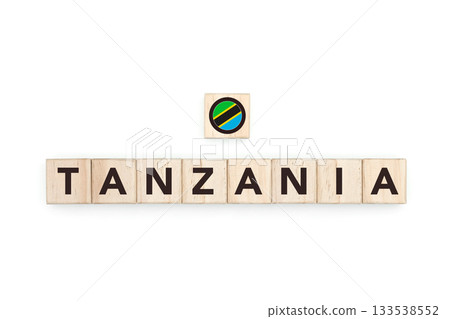 Wooden blocks bearing the name and flag of Tanzania. Tanzanian and South African Culture, national identity, travel, and geography in a copy space design. 133538552