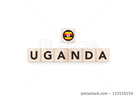 Wooden blocks bearing the name and flag of Uganda. Ugandan and African Culture, national identity, travel, and geography in a copy space design. 133538559