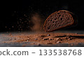 Sliced Chocolate Bread with Cocoa Powder and Dark Background for Culinary Concept 133538768