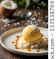 Creamy Mango Ice Cream on Rice with Coconut Shavings and Caramel Drizzle 133538769