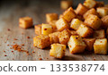 Golden Brown Crispy Seasoned Cubes on Wooden Surface Ready for Garnishing or Snacking 133538774