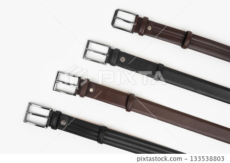 Leather Belts in Row on White Background Leather Belts in Row on White Background 133538803