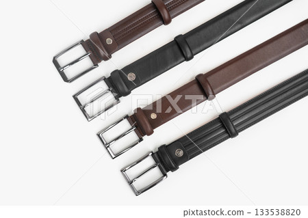 Leather Belts in Row on White Background Leather Belts in Row on White Background 133538820
