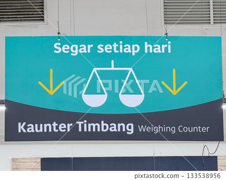 Weighing counter sign with scales and fresh produce message at grocery shop Weighing counter sign with scales and fresh produce message at grocery shop 133538956