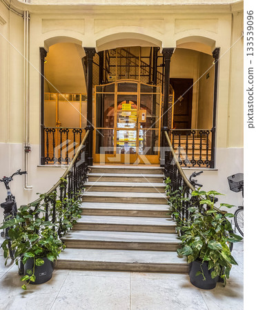 Elegant Interior Staircase with Vintage Elevator 133539096