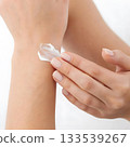 woman applying cream on her hands 133539267