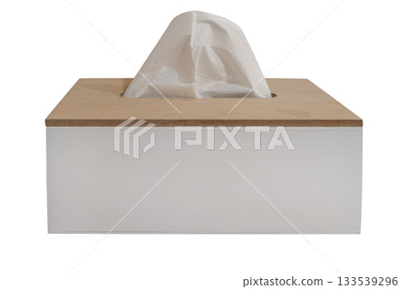 Minimalistic wooden tissue box with a white paper tissue sticking out isolated on white background. Clipping path 133539296