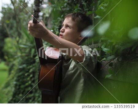 Boy Playing Guitar Outdoors with Passion Boy Playing Guitar Outdoors with Passion 133539519