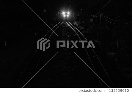 Light moving along the silent railway line - Night view of a local train line 133539610