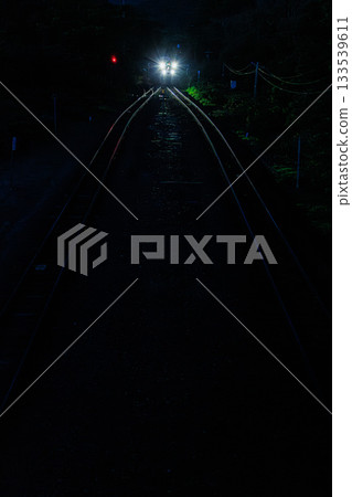 Headlights cutting through the darkness: Night train on the Hakodate Main Line 133539611