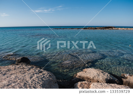 Rocky Sea Entrance at Elafonisi Beach with Clear Turquoise Water - Natural Coastal Texture of Crete 133539729