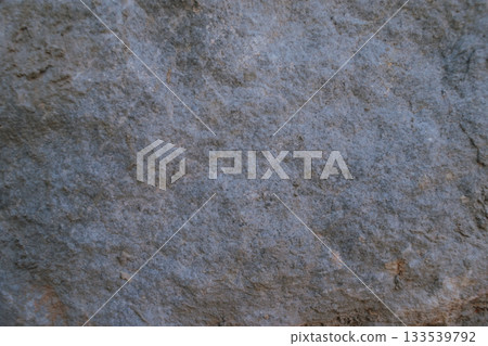 Close-up of grey stone surface texture, natural rock background Close-up of grey stone surface texture, natural rock background 133539792