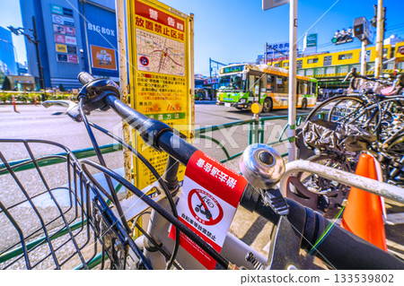 Tokyo cityscape in Japan, including Takadanobaba Station and abandoned bicycles with removal notices posted (November 21st) 133539802