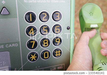 Public telephone number buttons. Close-up of retro equipment. 133540141