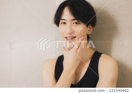 A young man looking at a mirror 133540982