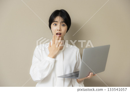 Woman using a laptop Woman using a laptop 133541057