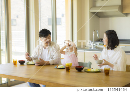 A happy family at the dinner table 133541464