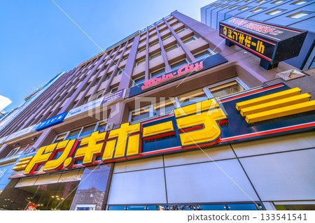 Tokyo cityscape in Japan, overlooking Don Quijote in front of Takadanobaba Station. Pigeon repellents line the signboards. (November 21st) 133541541