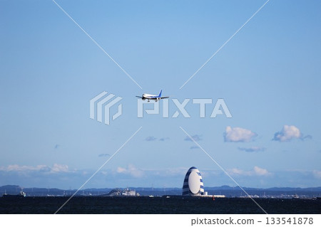 A plane about to land over Tokyo Bay 133541878