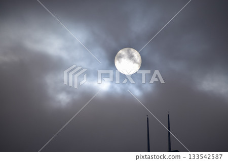 Full moon with dramatic cloudscape. Cloudy overcast sky with moon. Nature scene. 133542587