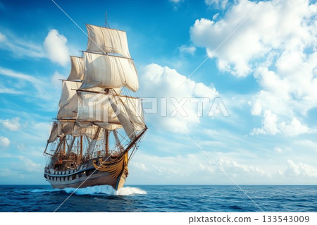 A majestic tall ship sails across the horizon under a bright blue sky with fluffy clouds 133543009