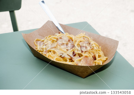 creamy spaghetti alla carbonara outdoors 133543058