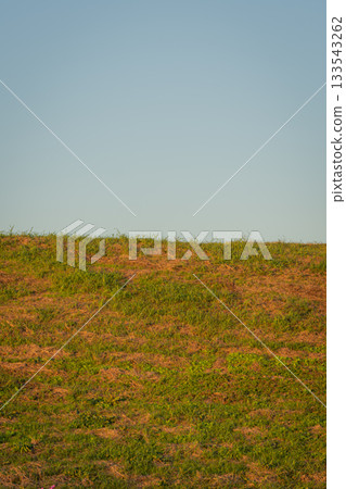 The riverbank and evening sky in Konosu City, Saitama Prefecture, with a vast white space as a background 133543262