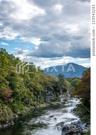The Arakawa River and mountain ranges of Nagatoro Valley, a majestic autumn landscape with the leaves beginning to change color The Arakawa River and mountain ranges of Nagatoro Valley, a majestic autumn landscape with the leaves beginning to change color 133543281