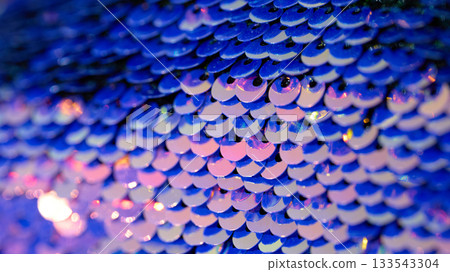 Close-up view of shiny blue sequins reflecting light 133543304