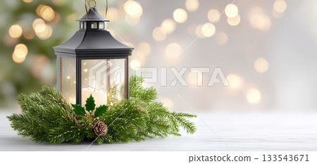 Beautiful lantern adorned with greenery and candle creates warm and inviting atmosphere perfect for Christmas celebrations. soft glow and festive decorations enhance holiday spirit 133543671