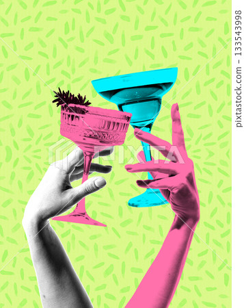Playful composition with hands raising colorful cocktail glasses. 133543998