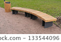 Empty wooden bench and trash can in city park. Concept of recreation, tanning 133544096