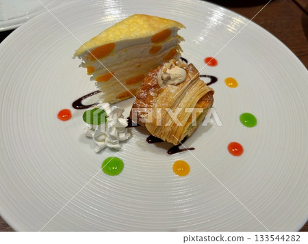 Luxury mango crepe and pie dessert served on a white plate 133544282