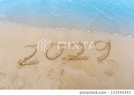 2029 numbers written on sandy background. Sea wave beach 2029 numbers written on sandy background. Sea wave beach 133544343
