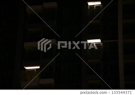 Close-up of the lamp at the residential housing. Lighting at night. Cityscape. Close-up of the lamp at the residential housing. Lighting at night. Cityscape. 133544371