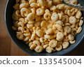 Bowl of Crunchy Breakfast Cereal with Spoon 133545004