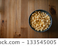Bowl of Milk and Cereal on Wooden Table 133545005