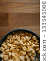Bowl of Milk and Cereal on Wooden Table 133545006