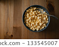 Bowl of Crunchy Breakfast Cereal with Spoon 133545007