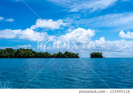 Rocky islets under blue sky, Togian Islands, Sulawesi, Indonesia Rocky islets under blue sky, Togian Islands, Sulawesi, Indonesia 133545116