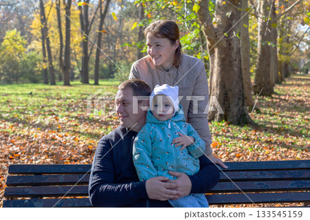 Lovely family in an autumn park. 133545159