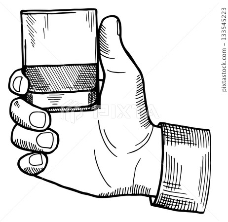 A hand holding a glass 133545223