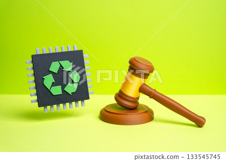 A chip with a recycling symbol and a judge's gavel. Laws and regulations for the recycling of electronic waste and components. ESG policy, tech regulation, and sustainability governance. A chip with a recycling symbol and a judge's gavel. Laws and regulations for the recycling of electronic waste and components. ESG policy, tech regulation, and sustainability governance. 133545745