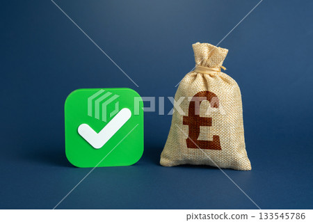 The British pound is a money bag and a seal of approval. A green checkmark in the checkbox. Legally established capital and tax-free. Secure financial assets and compliant business operations 133545786