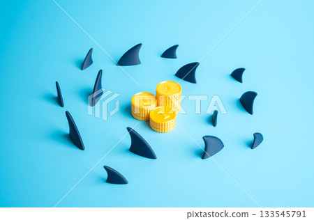Shark fins circle a stack of coins. The threat of losing money. Economic instability, fraud risks and crisis scenarios. Banking alerts and financial education. Shark fins circle a stack of coins. The threat of losing money. Economic instability, fraud risks and crisis scenarios. Banking alerts and financial education. 133545791