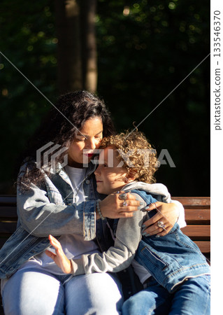 Joyful moment of happy mother spending time with her kid. Laughing, kissing, hugging, tickling. Parenthood moment. 133546370