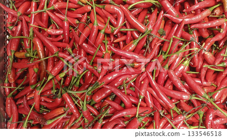 Red chili pepper pile fresh spicy vegetable market vibrant red and green stems creating energetic texture Red chili pepper pile fresh spicy vegetable market vibrant red and green stems creating energetic texture 133546518