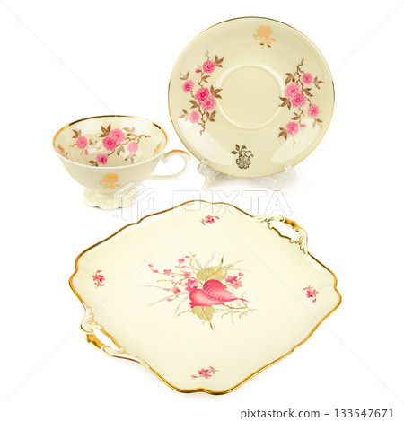 Vintage Floral Porcelain Set: Cup, Saucer, and Serving Platter Isolated on White 133547671