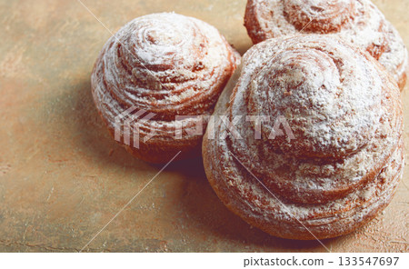 bakery product, lemon twist, with white glaze, sweet bun, muffin, pastries, top view, no people, 133547697